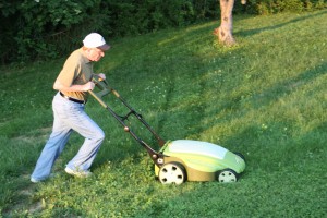 Gracey's dad cutting the lawn with Neuton mower